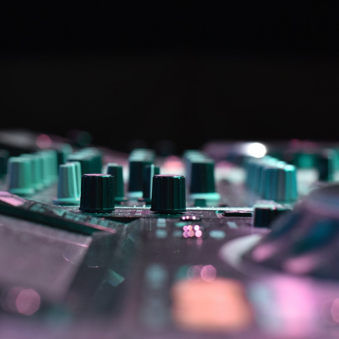 Audio mixing console with faders and knobs in a recording studio